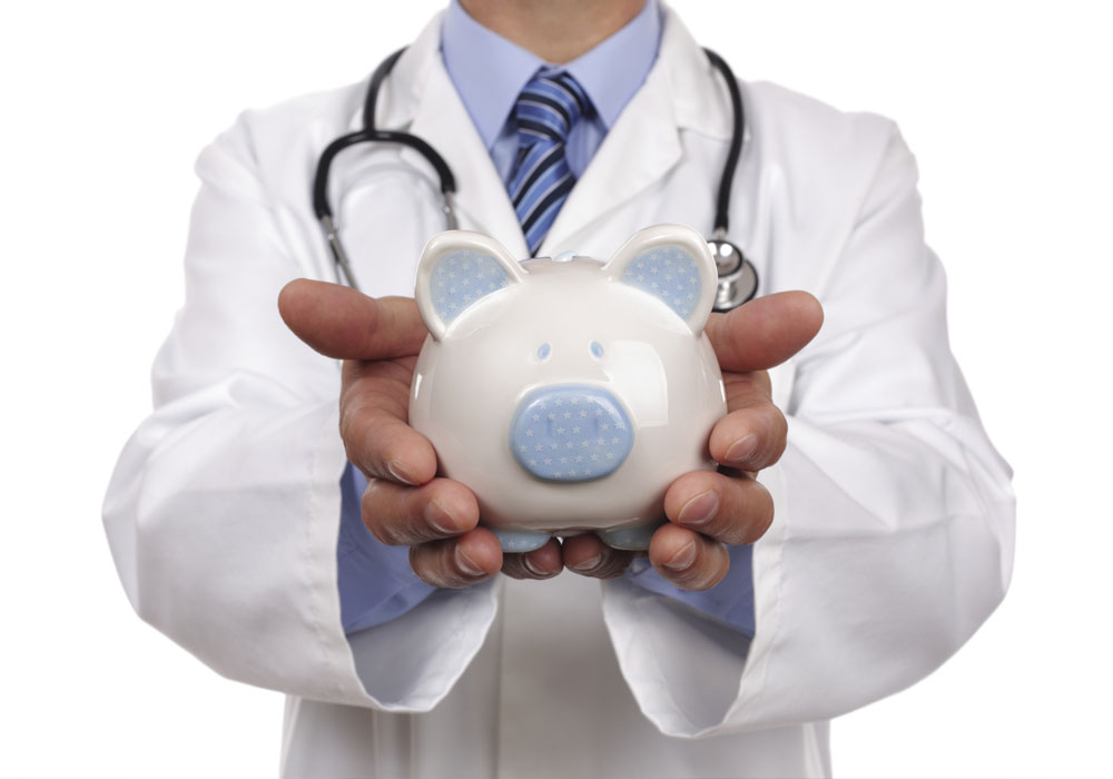 Doctor holding piggy bank for healthcare savings